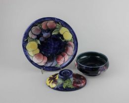 A Moorcroft pottery Anemone pattern bowl, a Wisteria pattern plate, and a Hibiscus pattern oval