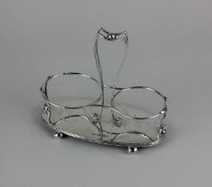 A Victorian silver two-bottle cruet stand with central handle on oval base and ball feet, maker John