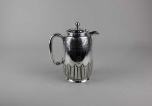 A Victorian silver hot water pot cylindrical demi reeded shape with engraved decoration and