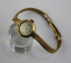 A Baume 9ct gold lady's bracelet wristwatch, the signed silvered dial with gilt Arabic and baton