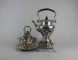 A Silver plated kettle on stand with burner together with a silver plated egg stand containing six