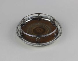 A George III silver bottle coaster open rim on pierced navette supports with reeded border on turned