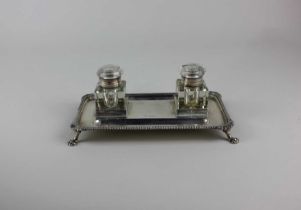 An early 20th century silver desk stand rectangular shape with two glass inkwells, gadrooned