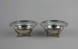 A pair of George V silver small circular dishes with pierced borders on three scroll feet, marks