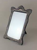 A modern silver framed dressing table mirror with a scrolled embossed border (a/f) Sheffield 1991,