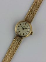 An Omega 9ct gold circular cased lady's bracelet wristwatch, the signed silvered dial with baton