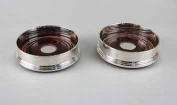 A pair of modern silver bottle coasters with turned wooden bases, maker Broadway & Co. Birmingham