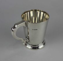 A George V silver mug plain tapered form with scroll handle, maker Charles Weale, Birmingham 1928,