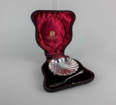 An Edward VII silver shell shaped butter dish and knife, London 1907, maker Josiah Williams & Co,