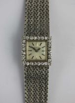 A Universal Geneve white gold and diamond ladies dress bracelet watch, the signed square silvered