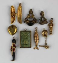 Five gold charms comprising American banknote, pod containing teacup, figure, fish and bear,