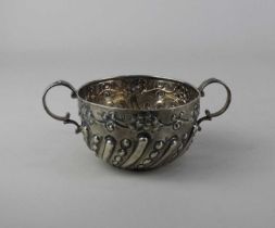 A Victorian silver two handled sugar bowl circular shape with spiral embossed reeding and floral