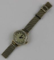 An 18ct gold cased and diamond set ladies dress wristwatch with an unsigned jewelled lever movement,