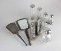 A Queen Elizabeth II silver dressing table handmirror and brush set with engine turned decoration