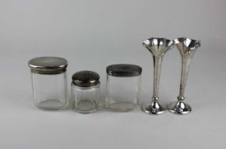 A pair of George V silver vases with flared wavy rims on circular loaded bases, maker John Dixon,