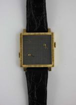 A Baume and Mercier gentlemans gold cased twin time square cased wristwatch, the signed textured
