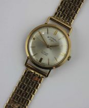 A Rotary 9ct gold circular cased gentleman's wristwatch fitted to a 9ct gold bracelet, the signed