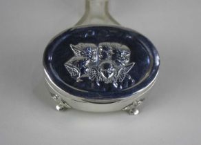 An Edward VII silver oval dressing table box the lid embossed with Reynolds Cherubs, Birmingham