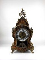 A gilt metal mounted boule style mantel clock, bombé-shaped, the dial set with enamelled panels