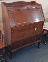 An early 20th century mahogany bureau with panelled fall front enclosing fitted interior with