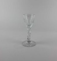 An 18th century drinking glass the round funnel bowl engraved with floral spray and bird on