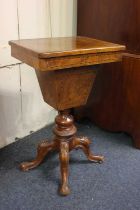 An Edwardian inlaid walnut sewing table rising top with fitted interior and silks box on carved