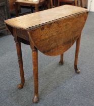 A small oak drop leaf table with oval top on tapered legs to pad feet 79cm