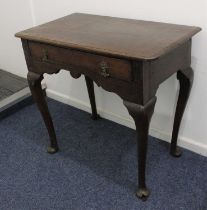 A George III oak lowboy with rounded and moulded rectangular top and shaped frieze on cabriole