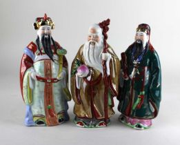 Three Chinese ceramic figures of immortals to include Shoulao 23cm high