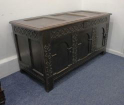 An 18th century oak coffer with blind fret three panel front, on block feet, 133cm