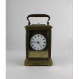 A 19th century gilt brass repeating carriage clock, the floral decorated case with bevelled glass