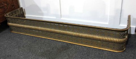 A pierced brass fire fender 127cm