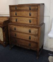 An early 20th century oak chest on chest of three drawers over three further drawers with pierced