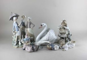 Eight Lladro porcelain figures to include a swan, boxed, a seated clown and a cherub (a/f)