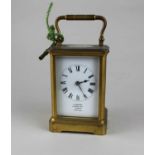 A small French gilt metal carriage clock, the white enamel dial with Roman numerals and inscribed 'J