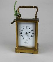 A small French gilt metal carriage clock, the white enamel dial with Roman numerals and inscribed 'J