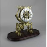 A brass skeleton clock with fusee movement, silvered chapter ring with Roman numerals, 24cm high,