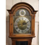 A 20th century longcase clock in a mahogany case with an arched pediment and glazed case door, brass