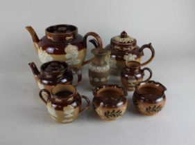 A collection of Royal Doulton glazed stoneware with Harvest design comprising of three tea pots,