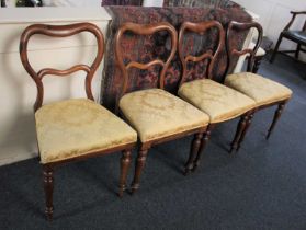 A set of four Victoria rosewood balloon back dining chairs on turned legs (a/f)