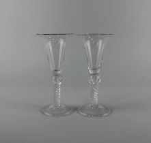 A pair of wine glasses, each with bell shaped bowl on an airtwist stem with swollen knop 18.5cm