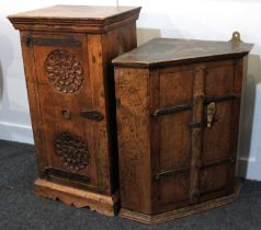 A small metal mounted oak corner cabinet with two panel doors enclosing cupboard 47cm and a