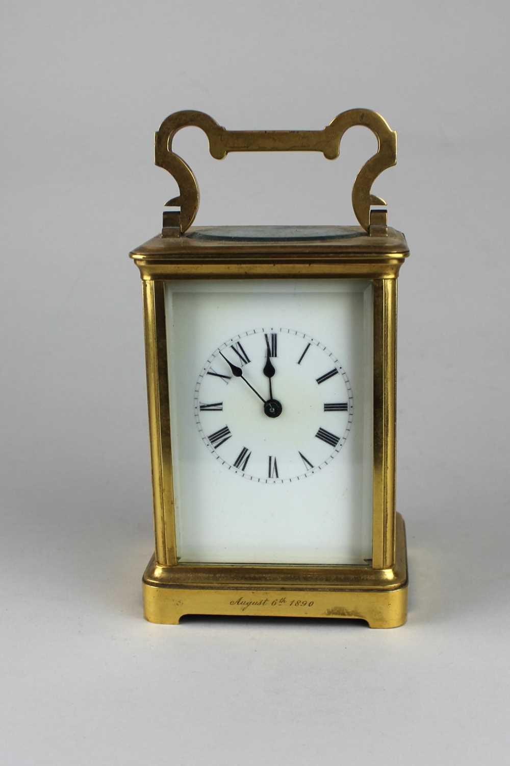 A 19th century French gilt brass carriage clock, the white enamel dial with Roman numerals, striking