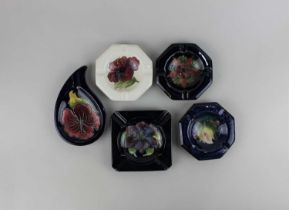 A collection of five Moorcroft pottery ashtrays, to include Columbine and Clematis pattern (a/f)