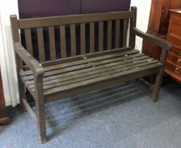 A wooden garden bench with slatted back and seat 122cm