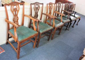 A set of four Chippendale style carver dining chairs with pierced ribbon backs and drop in seats