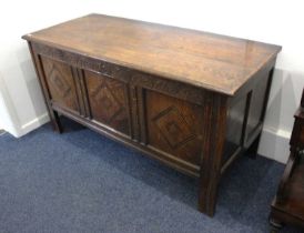 An 18th century oak coffer carved frieze with three inlaid diamond panel front, on block feet,