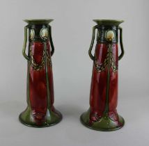 A pair of Minton Secessionist two-handled vases with deep red and green tube lined decoration,