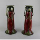 A pair of Minton Secessionist two-handled vases with deep red and green tube lined decoration,