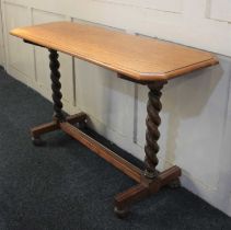 An oak side table spiral turned end supports with uniting stretcher and bun feet, 118cm